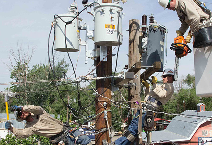 Linemen working on electric power pole
