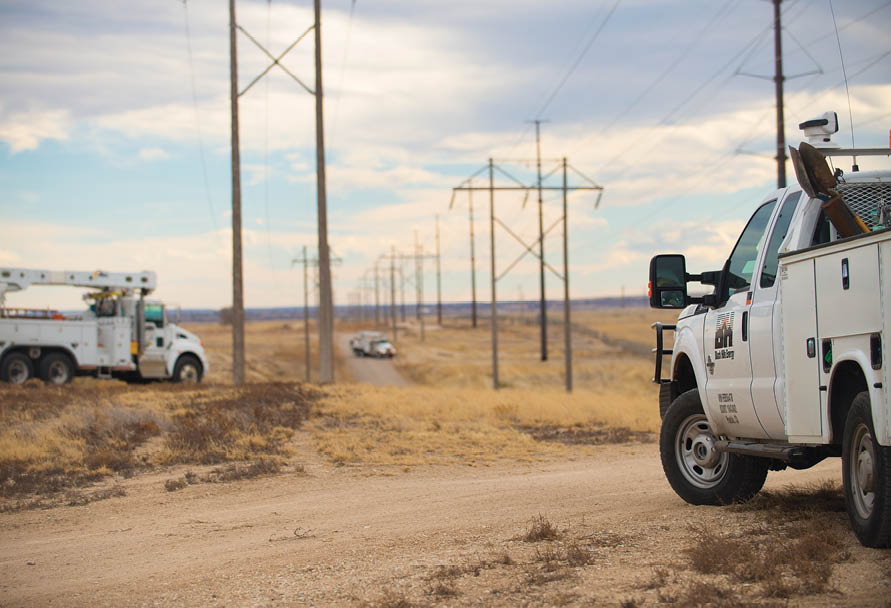 Image of utility trucks near power poles