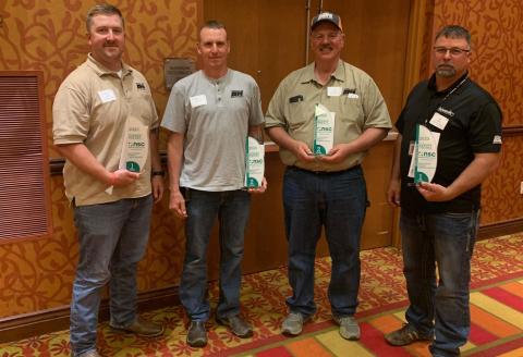 group of men posing with safety awards