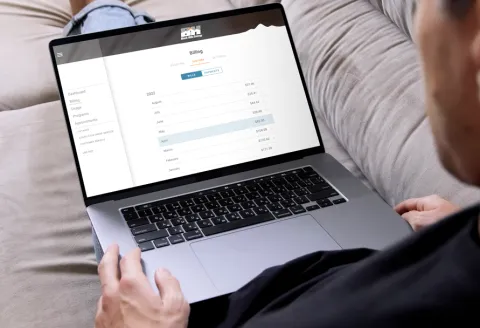 Close up of a person using their laptop to access their online account