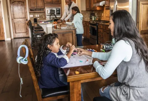Mother and daughter sitting at the kitchen table