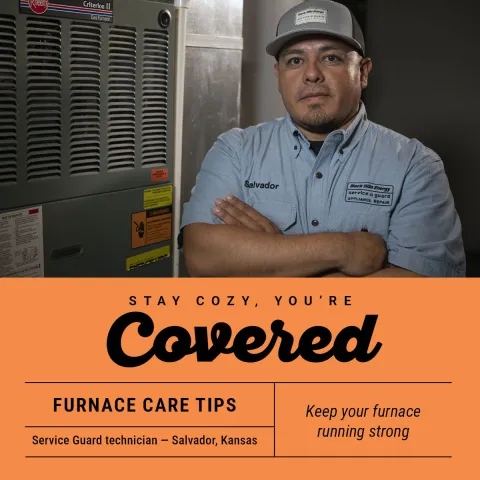 Service Guard technician standing in front of a furnace